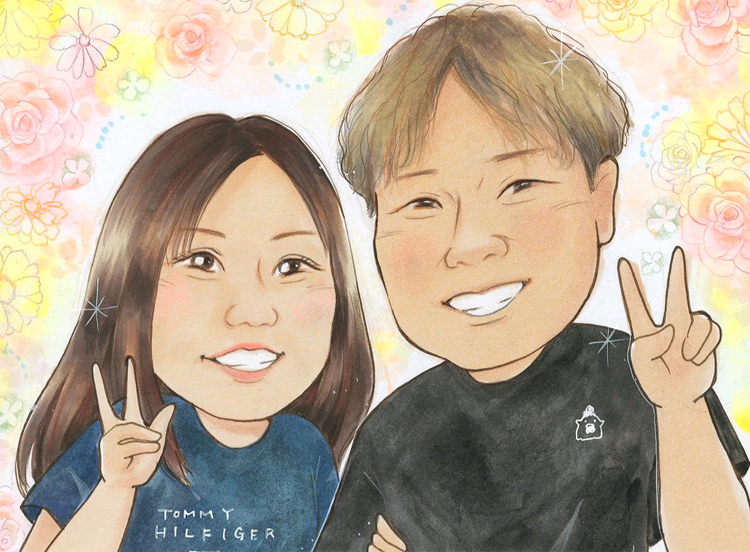Smiling couple posing with peace signs against a pastel floral background.